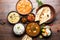 Indian lunch or dinner items like dal, paneer butter masala, roti, rice, salad