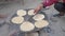 Indian making Indian Bread ( rotis )on stove in India