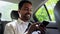 indian male passenger with smartphone in taxi car