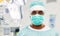 Indian male surgeon in mask over operating room
