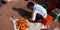 An Indian man arranging tomato at farmers field market