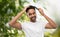 Indian man brushing hair over natural background