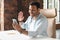 Indian man in casual wear using smartphone app for virtual communication