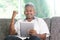 Indian man cheering while using tablet pc