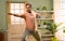 Indian man doing exercise by stretching hands during morning at home - concept of healthy lifestyle, fitness routine and