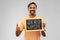 Indian man holding chalkboard with zero waste