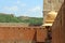 Indian man looking at the detail of Amer or Amber Fort in Jaipur.