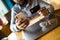 Indian man is making an on-line purchase via mobile pone, while is sitting in cafe with Overlooking the main street. Young guy is