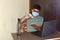 Indian man with medical mask for coronavirus covid-19 protection working in office, new normal business practise of coronavirus