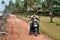 Indian man on motorbike on the road next to the Samudra beach