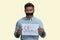 Indian man with mouth taped holding paper sheet with silence inscription.