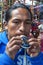 An Indian man playing a colourful flute at the Indian Market in Otavalo in Ecuador.