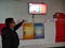 an indian man pointing hand into the digital marketing display screen at hero bike service center in India January 2020