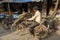 Indian man sharpens knives on cycle in street in Dharavi Slum at Mumbai. India