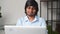 Indian man in smart casual shirt using laptop indoor