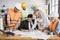 Indian man in suit presenting new construction project to colleagues in helmet and uniform at office