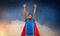 Indian man in superhero cape flying in night sky