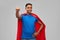 Indian man in superhero cape makes winning gesture