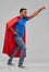 Indian man in superhero cape makes winning gesture