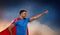 Indian man in superhero cape makes winning gesture