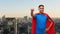 Indian man in superhero cape makes winning gesture