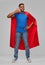 Indian man in superhero cape making call gesture