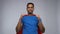 Indian man in superhero cape showing thumbs up