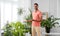 Indian man taking care of houseplants at home