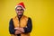 Indian man wearing stylish traditional kurta great smile in santa hat with gift box on yellow background studio.dark