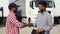 Indian manager and african trucker shaking hands by truck. Two people shaking hands on truck parking