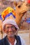 Indian mand standing with camel at Man Sagar Lake in Jaipur, Ind