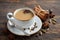 Indian masala chai tea. Spiced tea with milk on the rustic wooden table.