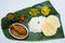 Indian meal with braised chiken and plain rice on banana leaf tr