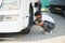 Indian Mechanic unscrews wheel truck pneumatic wrench