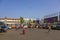 Indian men walk on the background of parked bright colorful buses at the bus station