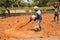 Indian men at work with seal to move the orange earth to cultivate food vegetables grass