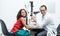 Indian middle aged professional ophthalmologist or optometrist man work at optometry clinic, using optometry instruments