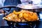 indian mixed vegatable dish sizzler with rice, fries, potato, vegetables cutlets and cabbage placed on iron dish being