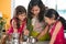 Indian mother cooking with her daughters