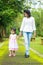 Indian mother and daughter walking outdoor.