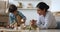 Indian mother play with little son wooden blocks