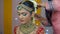 Indian mother putting Beli flower Gajra on her daughter hair bun - Indian bride