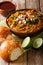 Indian Mumbai food Pav bhaji from vegetables with bread close-up in a bowl. vertical