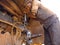 an indian old mechanic putting grease oil into the truck wheel during oiling work at automobile service center in India dec 2019