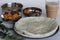 Indian pancakes also known as dosa made with fermented batter of rice and lentils. Served with idli podi chutney, sambar, coconut