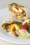 Indian paneer roll or twister with side salad on white plate