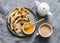 Indian paratha flatbread with honey and masala tea on grey background, top view