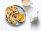 Indian paratha flatbread with honey and masala tea on light background, top view