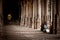 Indian people pilgrim resting inside ancient colonnade of Meenakshi Temple