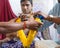 Indian people received flower garland from priest.